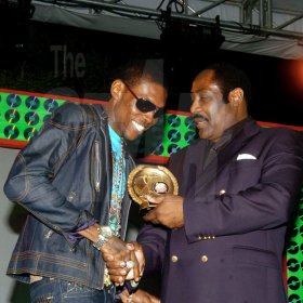 Winston Sill / Freelance Photographer
Vybz Kartel (left) smiles as he receives one of his awards from Jamaica Football Federation (JFF) President Captain Horace Burrell at the EME Awards Presentation Show, held at the Jamaica Pegasus Hotel, New Kingston on Thursday night.