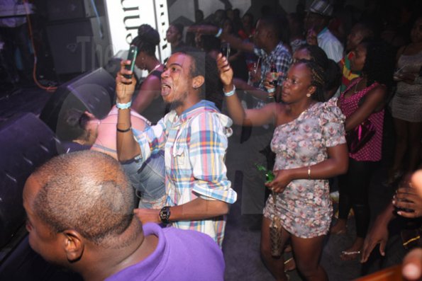 Anthony Minott/Freelance Photographer
Patrons capture the moment during Aidonia in concert at Famous Night Club last Sunday.