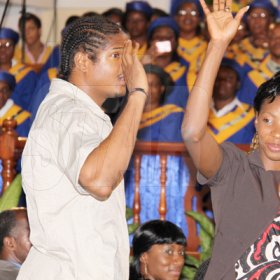 Anthony Minott/Freelance Photographer 
World and Olympic 400m champion, Mellaine Walker (right), and 400m specialist, Germaine Gonzales greet the audience during a celebratory service for Jamaica's Berlin World championships athletes at the Portmore Seventh Day adventist church on Saturday, October 3, 2009.