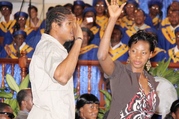 Anthony Minott/Freelance Photographer 
World and Olympic 400m champion, Mellaine Walker (right), and 400m specialist, Germaine Gonzales greet the audience during a celebratory service for Jamaica's Berlin World championships athletes at the Portmore Seventh Day adventist church on Saturday, October 3, 2009.