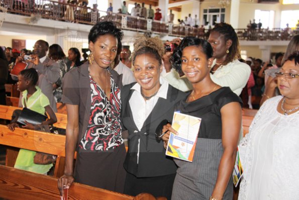 Anthony Minott/Freelance Photographer 
World and Olympic champions Shelly-ann Frasier, (right), and Mellaine Walker (left), pose for a photograph with an unidentified woman during a celebratory service for Jamaica's Berlin World championships athletes at the Portmore Seventh Day adventist church on Saturday, October 3, 2009.