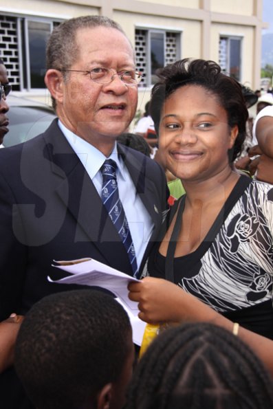 Anthony Minott/Freelance Photographer 
Prime Minister Bruce Golding pose with a young lady during a celebratory service for Jamaica's Berlin World championships athletes at the Portmore Seventh Day adventist church on Saturday, October 3, 2009.