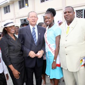Anthony Minott/Freelance Photographer 
Miss Teen Portmore 2009, Michelle Cole (second right), pose beside Prime Minister Bruce Golding (second left), Mayor of Portmore Keith Hinds, (right), and the Mayor's wife, Majorie. The ocassion was a celebratory service for Jamaica's Berlin World championships athletes at the Portmore Seventh Day adventist church on Saturday, October 3, 2009.