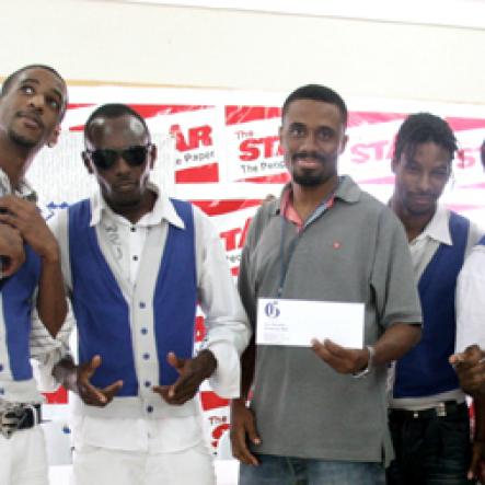 Roxroy McLean
The Gleaner's entertainment editor LeVaughn Flynn presents a cash prize to winners Shady Squad.