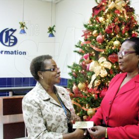 Contributed
Elaine Sullivan (right), The Gleaner's Usain 9.58 Party Superfan winner, receives two VIP passes from Karin Cooper, Business Development and Marketing Manager, at The Gleaner on Wednesday. Sullivan's submission on why she is Usain Bolt's biggest fan was voted the best of about 30 entrants. Bolt's 9.58 Super Party takes place on Saturday at Richmond Estate in St Ann.