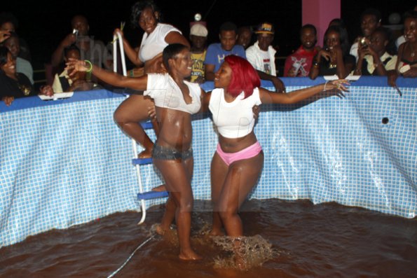 Anthony Minott/Freelance Photographer
Yanique Frazer (right), and Trudy Powell battle in a mud pit during Booty Fridays at the Sky Terrace Rajmaville Mall, Hellshire Main Road, on Friday, June 8, 2012. Frazer won as Trudy was disqualified for an illegal ploy.