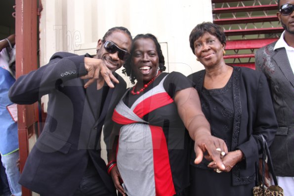 Anthony Minott/Freelance Photographer
Ivy Williams, (right), mother of DJ Bounty Killer, aka Rodney Price  pose beside her son, and Evangelist Yvette Blake, a member of the host church after a church service on Sunday, April 18, 2010.
