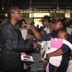 Anthony Minott/Freelance Photographer
STAY IN CHURCH: A woman gestures to DJ Bounty Killer, aka Rodney Price  after a church service at the Agape Christian Fellowship on Sunday, April 18, 2010.