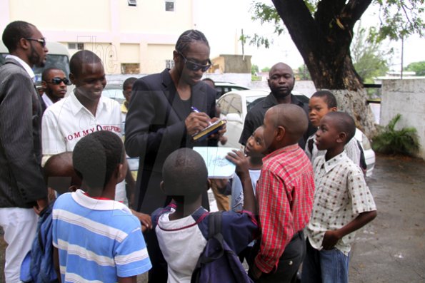 Anthony Minott/Freelance Photographer
 DJ Bounty Killer, aka Rodney Price signs autographs for children after a church service at the Agape Christian Fellowship church, located in Cedar Grove, Portmore, St Catherine on Sunday, April 18, 2010.