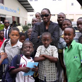 Anthony Minott/Freelance Photographer 
DJ Bounty Killer, aka Rodney Price pose with his young fans after a church service at the Agape Christian Fellowship church on Sunday, April 18, 2010.