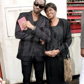 Anthony Minott/Freelance Photographer
                                                                                         Bounty Killer (left) and his mother Ivy 'Mama Ivy' Williams, after a church service at the Agape Christian Fellowship church on Sunday, April 18, 2010.