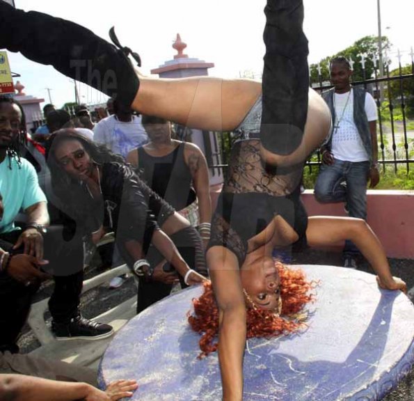 Anthony Minott/Freelance Photographer
The newly crowned Dancehall Queen, Sher Rumbar dances on her head during the making of the music video, for the outrageous dance Broad out, by Jah Jah and Ashe at the Portmore Town Centre Plaza, on Wednesday, September 5, 2012.
