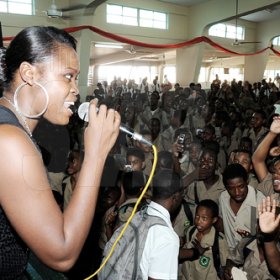 Ian Allen/Photographer
Digicel Rising Stars winner Camille Davis thrills students at Calabar High during the Gleaner 'Champs 100' School Tour yesterday. 

Champs 100 celebration at Calabar High School.