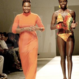 Winston Sill/Freelance Photographer
Cassandra Mottley (left) walks down the runway with a model wearing a creation from her Sheneil line at Caribbean Fashionweek last Friday at the National Indoor Sports Centre.



2009, Fashion Shows,held at the National Indoor Sports Centre (NISC), Independence Park on Friday night June 12, 2009.