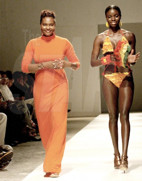 Winston Sill/Freelance Photographer
Cassandra Mottley (left) walks down the runway with a model wearing a creation from her Sheneil line at Caribbean Fashionweek last Friday at the National Indoor Sports Centre.



2009, Fashion Shows,held at the National Indoor Sports Centre (NISC), Independence Park on Friday night June 12, 2009.
