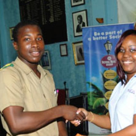 Ricardo Makyn/Staff Photographer.
VMBS representative, Titania Meredith (Right) presents a lucky St. Jago High student with a gift bag at The Gleaner Champs 100 Tour at St. Jago High on Friday, February 26, 2010.