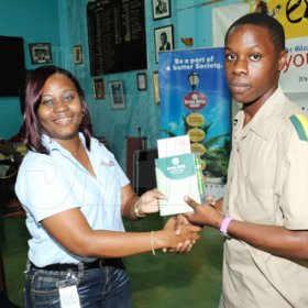 Ricardo Makyn/Staff Photographer.
VMBS representative, Titania Meredith (Left) presents a St. Jago High student with a gift at The Gleaner Champs 100 Tour at St. Jago High on Friday, February 26, 2010.