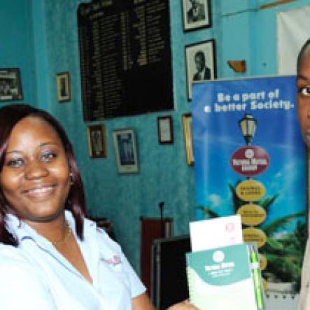 Ricardo Makyn/Staff Photographer.
VMBS representative, Titania Meredith (Left) presents a St. Jago High student with a gift at The Gleaner Champs 100 Tour at St. Jago High on Friday, February 26, 2010.