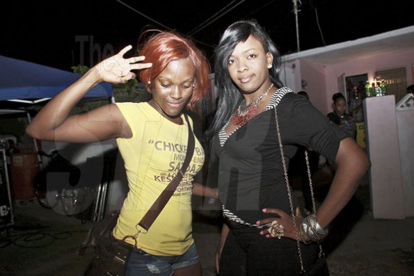 Anthony Minott/Freelance Photographer
Chicken Back Satdaze promoter, Kimone (left), and her friend take a photo opt during the monthly party, Chicken Back Satdaze at Keswick Avenue, Cumberland, Portmore, St Catherine on Saturday, April 28, 2012.