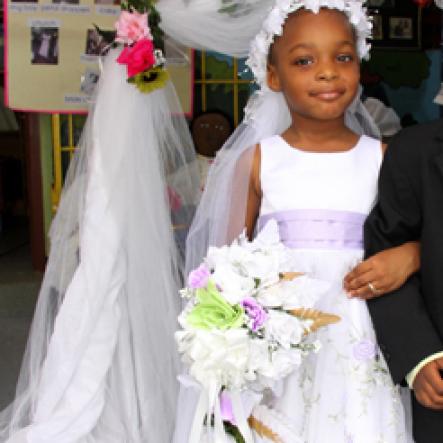 Anthony Minott/Freelance Photographer
NEWLY WEDS:  Bride Moya Green and groom Javier Foster pose for a photo shoot after they got married during a role play of a wedding ceremony at the Bridgeport Infant school, in Portmore, St Catherine on Friday, November 13, 2009.