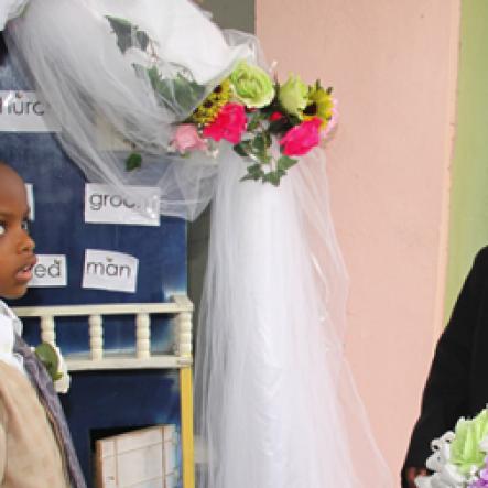 Anthony Minott/Freelance Photographer
Pastor Daniel Stephenson, marry bride, Moya Green and groom, Javier Foster  during a role play of a wedding ceremony at the Bridgeport Infant school, in Portmore, St Catherine on Friday, November 13, 2009.