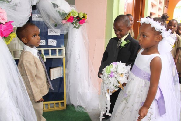 Anthony Minott/Freelance Photographer
Pastor Daniel Stephenson, marry bride, Moya Green and groom, Javier Foster  during a role play of a wedding ceremony at the Bridgeport Infant school, in Portmore, St Catherine on Friday, November 13, 2009.