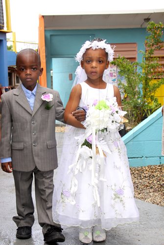 Anthony Minott/Freelance Photographer
Give-away father, Mrak-Twaine Davidson walks down the aisle with the bride, Moya Green during a role play of a wedding ceremony at the Bridgeport Infant school, in Portmore, St Catherine on Friday, November 13, 2009.