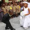 Anthony Minott/Freelance Photographer
The groom, Javier Foster (left), bows as his bride Moya Green, and her give-away father, Mark-Twaine Davidson approaches during a role play of a wedding ceremony at the Bridgeport Infant school, in Portmore, St Catherine on Friday, November 13, 2009.