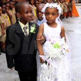 Anthony Minott/Freelance Photographer
The groom, Javier Foster (left), takes his bride Moya Green to the alter as the give away father, Mark-Twain Davidson (background), and children look on during a role play of a wedding ceremony at the Bridgeport Infant school, in Portmore, St Catherine on Friday, November 13, 2009.