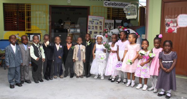 Anthony Minott/Freelance Photographer
The bridal party pose for photos during a role play of a wedding ceremony at the Bridgeport Infant school, in Portmore, St Catherine on Friday, November 13, 2009.