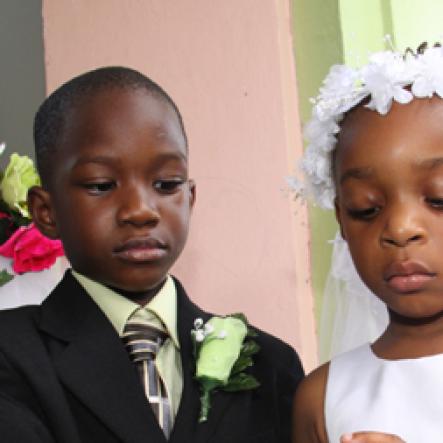 Anthony Minott/Freelance Photographer
The groom, Javier Foster (left), slips on the ring on the finger of his beautiful bride, Moya Green during a role play of a wedding ceremony at the Bridgeport Infant school, in Portmore, St Catherine on Friday, November 13, 2009.