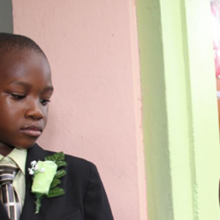 Anthony Minott/Freelance Photographer
Bride Moya Green (right), slips on the ring on groom Javier Foster during a role play of a wedding ceremony at the Bridgeport Infant school, in Portmore, St Catherine on Friday, November 13, 2009.