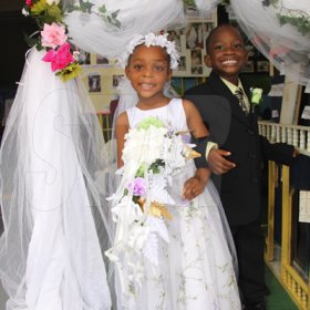 Anthony Minott/Freelance Photographer
NEWLY WEDS: Bride, Moya Green and her groom, Javier Foster pose for photos after they got married during a role play of a wedding ceremony at the Bridgeport Infant school, in Portmore, St Catherine on Friday, November 13, 2009.