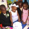 Anthony Minott/Freelance Photographer
Bride, Moya Green (2nd left), and her groom, Javier Foster (left), cuts the wedding cake, as members of the bridal party look on during a role play of a wedding ceremony at the Bridgeport Infant school, in Portmore, St Catherine on Friday, November 13, 2009.