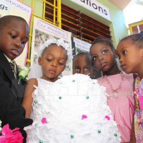 Anthony Minott/Freelance Photographer
The groom, Javier Foster, bride, Moya Green and others from the bridal party observe a cake during a role play of a wedding ceremony at the Bridgeport Infant school, in Portmore, St Catherine on Friday, November 13, 2009.