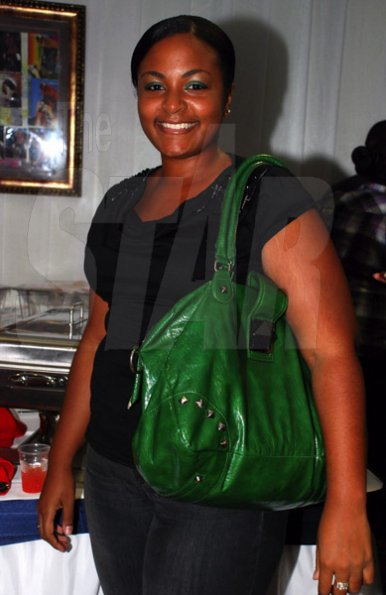 Colin Hamilton/PHOTOGRAPHER
Ayesha Dawes seems happy with her big green bag at 
Chino Album Launch at the Devonshire Hotel on Monday May 24, 2011.