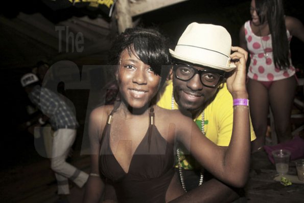 Anthony Minott/Freelance Photographer
GWhizz, and one of his female fans pose for the camera during RumBar Chug it Sugarman's Beach, Hellshire, Portmore, St Catherine, on Sunday, July 8, 2012