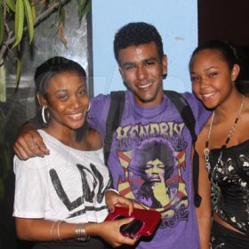 Anthony Minott/Freelance Photographer
LUCKY GUY: A young enjoys the company of two beautiful girls at Grandeur party held recently at Club Impulse, in New Kingston recently.