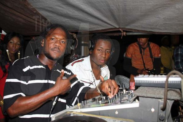 Anthony Minott/Freelance Photographer
Container Satdaz selectors, DJ Barge (left), and DJ Damion put on a juggling show during Container Boss, Ian "Don Ian' Miles Birth night party at 2 Chelsea Avenue, New Kingston, Saturday, January 21, 2012.
