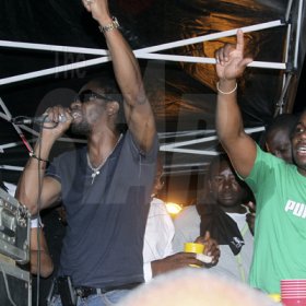 Anthony Minott/Freelance Photographer
DJ Bounty Killer (left), endorsing Container Satdayz, as promoter Don Ian feels the vibes during Container Satdayz, the lollipop edition, held on Regent Street, Down Town, Kingston, on Saturday, November 12, 2011.