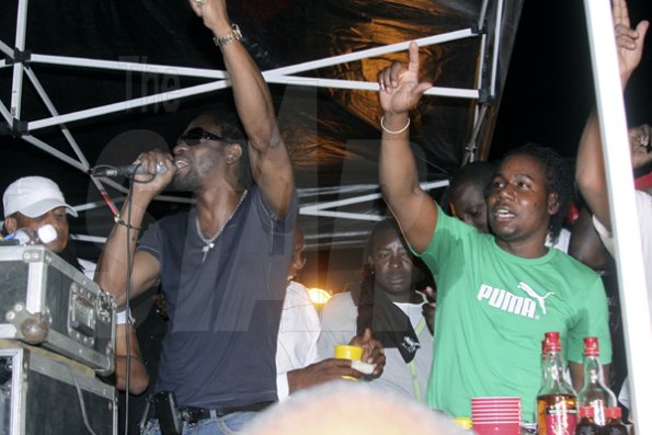 Anthony Minott/Freelance Photographer
DJ Bounty Killer (left), endorsing Container Satdayz, as promoter Don Ian feels the vibes during Container Satdayz, the lollipop edition, held on Regent Street, Down Town, Kingston, on Saturday, November 12, 2011.