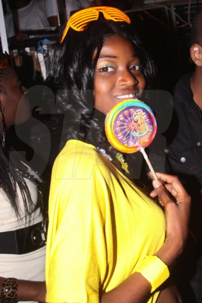 Anthony Minott/Freelance Photographer
A woman pose with a lollipop during Container Satdayz, the lollipop edition, held on Regent Street, Down Town, Kingston, on Saturday, November 12, 2011.