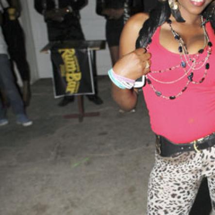 Anthony Minott/Freelance Photographer
A lady strikes a pose during Container Satdaze, Recent Street, Denham Town, West Kingston, on Saturday, March 24, 2012.