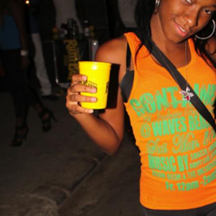 Anthony Minott/Freelance Photographer 
Sassy K shows off her cup and physique during Container Satdaze, Recent Street, Denham Town, West Kingston, on Saturday, March 24, 2012.