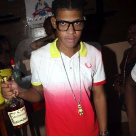 Anthony Minott/Freelance Photographer
With Hennessey in hand he's ready to party during Sher RumBar and Jodi Couture's Magnum Couture Girls party at the Village Blue Cafe, Barbican Road, in St Andrew on Saturday, June 16, 2012.
