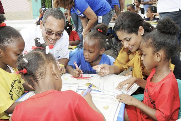 Gladstone Taylor / Photographer

Christopher Barnes, managing director of The Gleaner Company and Lisa Hanna, minister of youth and culture interact with children from basic schools downtown Kingston, during an after school event at The Gleaner's parking lot along east street. The schools were chosen by the National Child Month Committee.