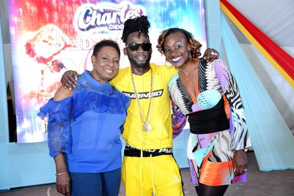 Rudolph Brown/Photographer<\n>Just touch down for Charles Chocolates Dancin Dynamite's <\n>2019 launch is British artiste Stylo G who is sandwiched by the show's producer Jenny Jenny (right) and Olivia Grange, Minister of Culture, Gender, Entertainment and Sport.<\n><\n><\n>