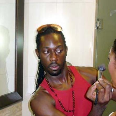 Director and stylist Dexter Pottinger adds the final touches to D'Angel's look.