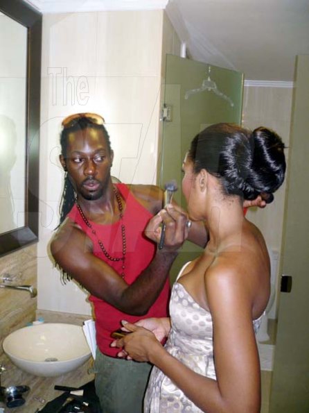 Director and stylist Dexter Pottinger adds the final touches to D'Angel's look.