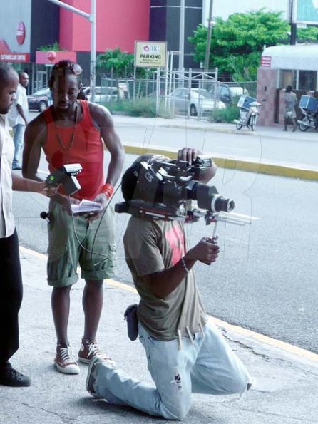 Director Dexter 3D Pottinger as he watches as Ras Tingle films a scene in New Kgn